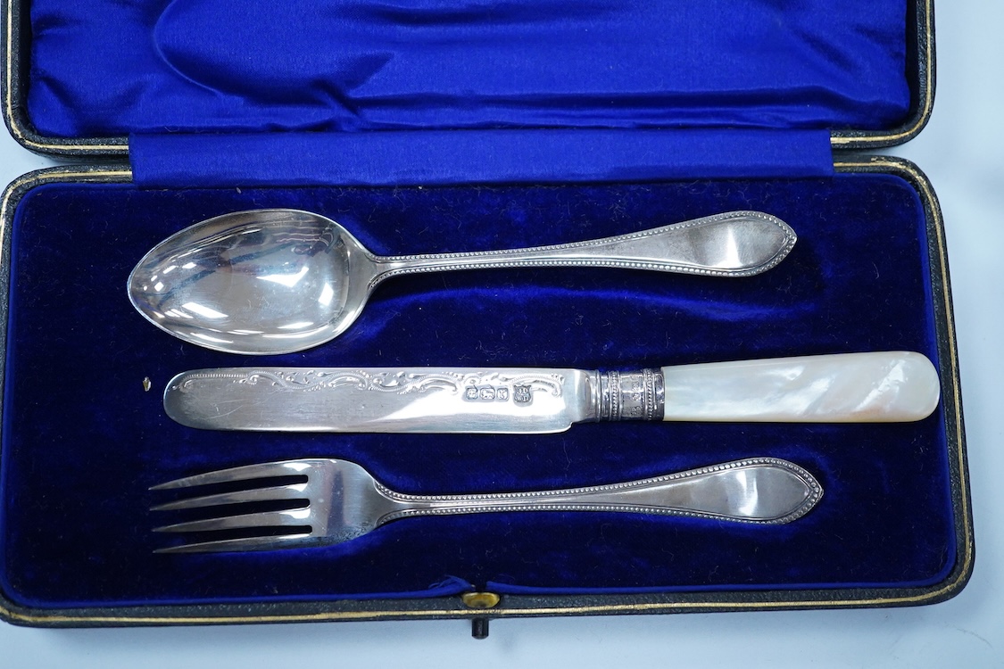 A cased pair of George III engraved silver Old English pattern berry spoons, by Smith & Fearn, London, 1794/5, 22.6cm, together with a cased Edwardian silver christening trio, an 800 standard mustard pot with white metal